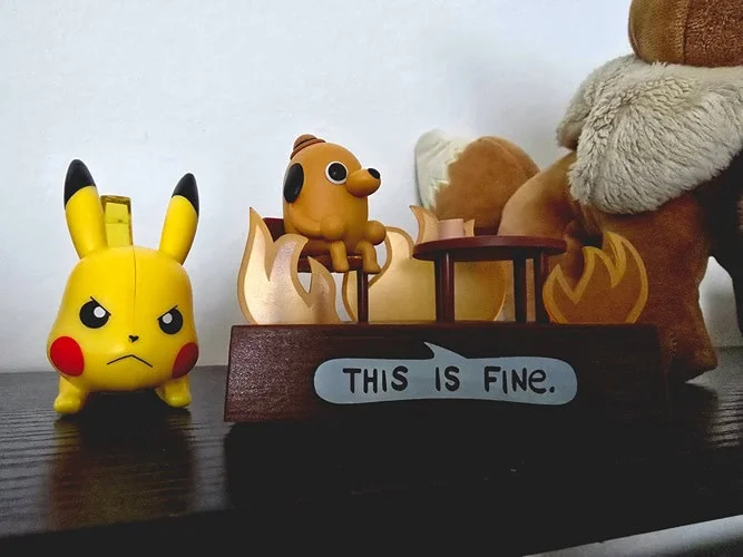 this is fine figurine next to angry Pikachu figurine in front of the side of an eevee holiday plush on top of black shelf