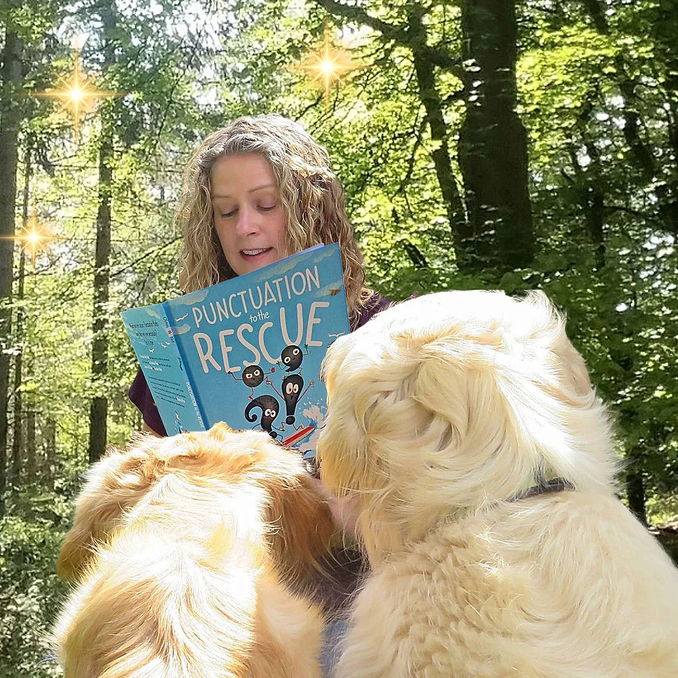 A woman reads "Punctuation to the Rescue" to two dogs in a sunlit forest, with glowing stars above.
